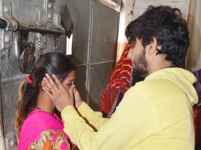 A newly-wed woman meets her husband who is a prisoner at Central Jail Amritsar. The jail authorities had made special arrangements on the occasion of ‘Karva Chauth' in Amritsar on Friday. (Sameer Sehga/ HT photo)