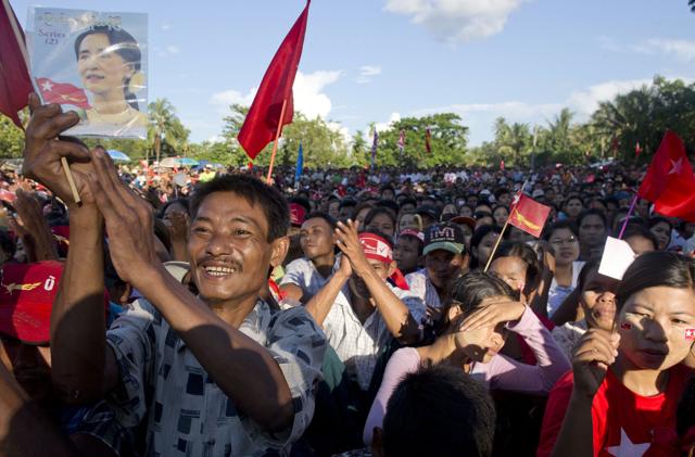 Supporters of Myanmar's opposition leader Aung San Suu Kyi applaud as Suu Kyi delivers a speech during a campaign rally of National League for Democracy party in Taungok, western Rakhine state, Myanmar. (AP Photo)