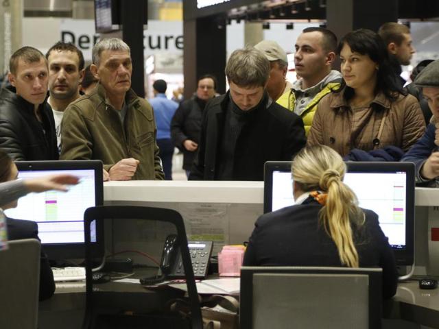 People gather at the airline information desk at of Russian airline Kogalymavia’s desk at Pulkovo airport in St.Petersburg, Russia. (AP Photo)