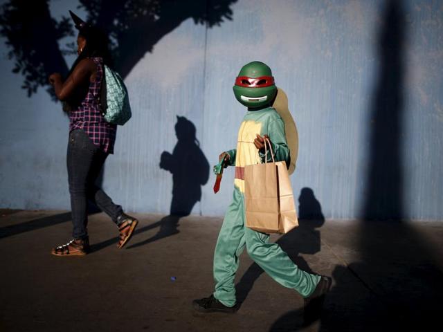 Children participate in the School on Wheels Skid Row Halloween Parade for children who live in shelters, motels, cars and on the street, in Los Angeles, California. (REUTERS)