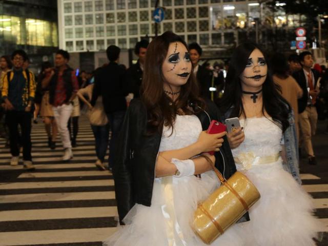 In this picture taken early on October 31, 2015, people wear costumes as they take part in a Halloween parade in Tokyo. Tens of thousands of people gathered at Tokyo's Shibuya fashion district to celebrate Halloween. (AFP)