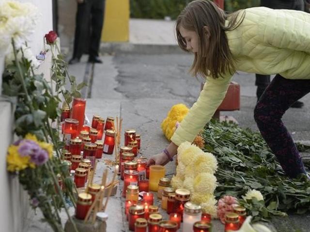 A woman lights a candle outside a nightclub, where a fire broke out on Friday, in Bucharest, Romania. (Reuters Photo) A woman lights a candle outside a nightclub, where a fire broke out on Friday, in Bucharest, Romania. (Reuters Photo)