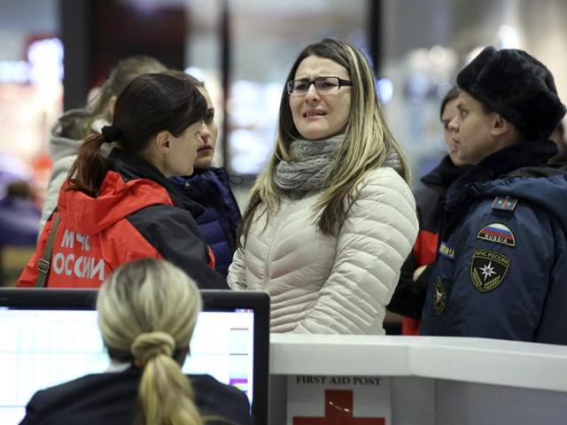 A woman reacts next to Russian emergencies ministry members at Pulkovo airport in St. Petersburg, Russia.(REUTERS) A woman reacts next to Russian emergencies ministry members at Pulkovo airport in St. Petersburg, Russia.(REUTERS)