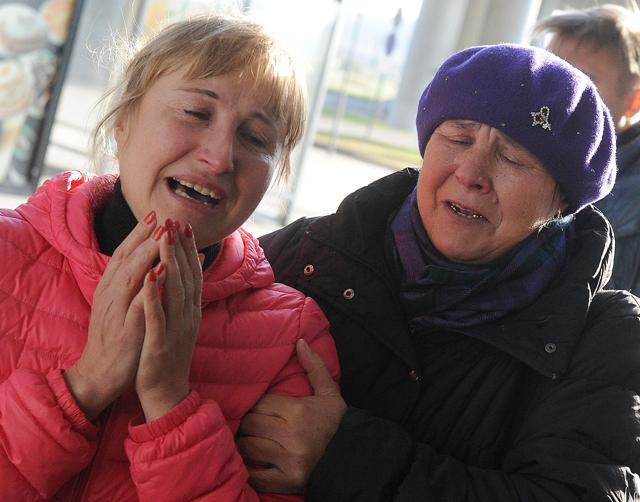 Relatives react at Pulkovo international airport outside Saint Petersburg. (AFP) Relatives react at Pulkovo international airport outside Saint Petersburg. (AFP)