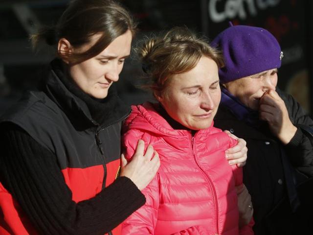 Relatives of the victims of a crashed Russian airliner with 217 passengers and seven crew aboard, help each other as they gathering at Pulkovo airport in St.Petersburg, Russia. (AP Photo)