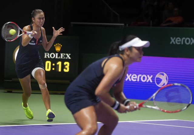 Taiwan's Chan Hao-Ching, left, hits a return as her sister Chan Yung-Jan, right, watches on during the match. (AP Photo) Taiwan's Chan Hao-Ching, left, hits a return as her sister Chan Yung-Jan, right, watches on during the match. (AP Photo)