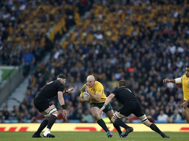 Australia's hooker and captain Stephen Moore (C) runs to evade New Zealand's number 8 Kieran Read (L) and New Zealand's flanker and captain Richie McCaw (2R). (AFP)