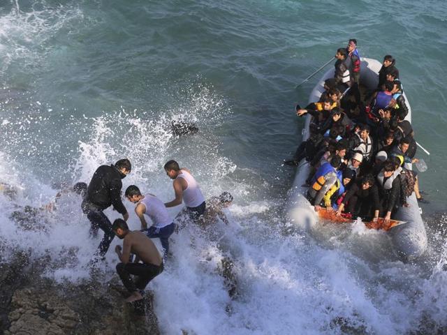 Refugees and migrants abort their effort on a dingy as they set out, trying to travel from the Turkish coast to the Greek island of Chios. (AP) Refugees and migrants abort their effort on a dingy as they set out, trying to travel from the Turkish coast to the Greek island of Chios. (AP)