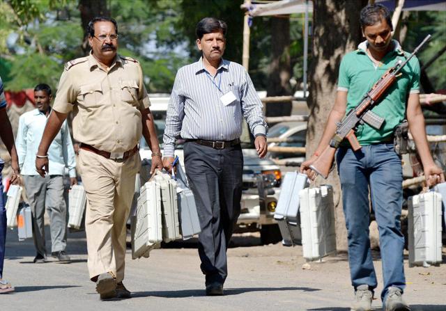 Policeman carry EVMs ahead of polling in the 4th phase of Bihar assembly polls in Muzaffarpur. (PTI) Policeman carry EVMs ahead of polling in the 4th phase of Bihar assembly polls in Muzaffarpur. (PTI)