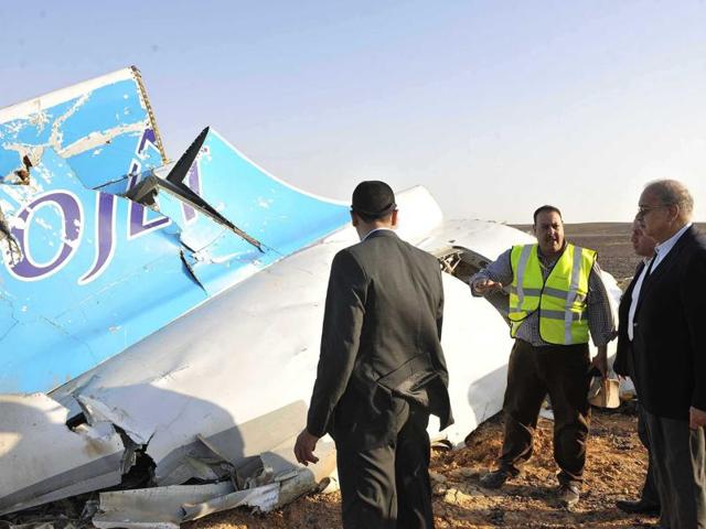 In this photo released by the Egypt Prime Minister's Office, Sherif Ismail, right, looks at the remains of a crashed passenger jet in Hassana. (Suliman el-Oteify/Egyptian Prime Minister's Office via AP)(AP) In this photo released by the Egypt Prime Minister's Office, Sherif Ismail, right, looks at the remains of a crashed passenger jet in Hassana. (Suliman el-Oteify/Egyptian Prime Minister's Office via AP)(AP)
