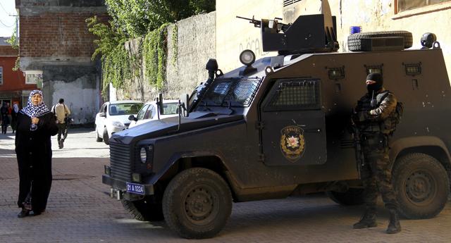 A woman arrives to vote as she walks past Turkish special police personnel outside a polling station in Diyarbakir. (Reuters) A woman arrives to vote as she walks past Turkish special police personnel outside a polling station in Diyarbakir. (Reuters)