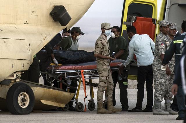 Egyptian paramedics load the corpses of Russian victim. (AFP) Egyptian paramedics load the corpses of Russian victim. (AFP)