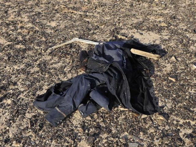 An item of clothing lies at the site where a passenger plane crashed in Hassana, Egypt. A Russian aircraft carrying 224 people, including 17 children, crashed Saturday in a remote mountainous region in the Sinai Peninsula. There were no survivors. (Egypt Prime Minister's Office/ AP Photo)