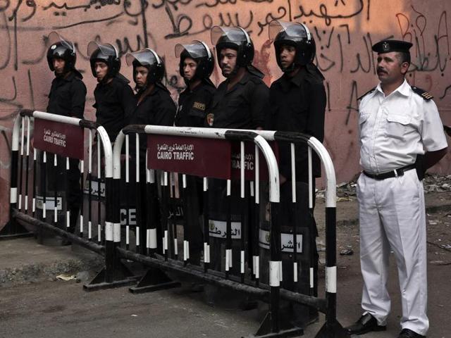 Security forces and police stand guard before ambulances with bodies of Russian plane crash victims arrive to Zeinhom morgue, in Cairo, Egypt. (AP Photo)
