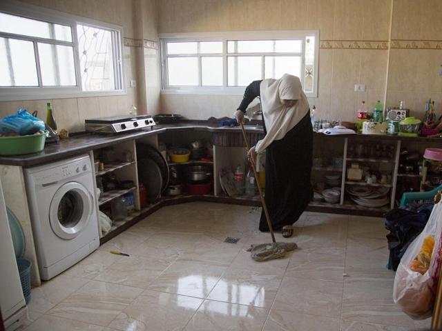 Um Alabed al-Zaza mops her new kitchen in a house that was completely destroyed during the last summer's war between Israel and Hamas, in Gaza City. (AP) Um Alabed al-Zaza mops her new kitchen in a house that was completely destroyed during the last summer's war between Israel and Hamas, in Gaza City. (AP)