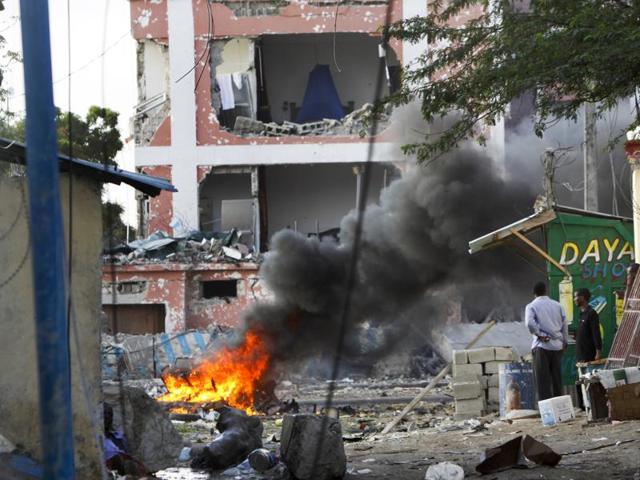 Somali policemen carry a wounded person to an ambulance outside the Sahafi Hotel in Mogadishu, Somalia. (AP) Somali policemen carry a wounded person to an ambulance outside the Sahafi Hotel in Mogadishu, Somalia. (AP)
