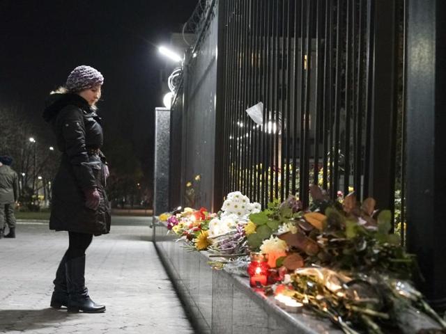 A Ukrainian woman pays tribute to victims of a Russian plane crash in front of the Russian Embassy in Kiev, Ukraine. (AP Photo)