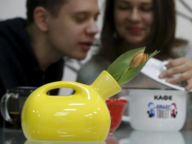 A flower vase designed in the likeness of urinal is seen at Crazy Toilet Cafe in Moscow, October 30, 2015. The walls are decorated with faeces-themed cartoons. (REUTERS)