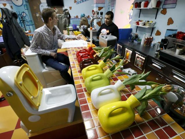 Flower vases designed in the likeness of urinals are seen on a counter at Crazy Toilet Cafe Moscow. (REUTERS)