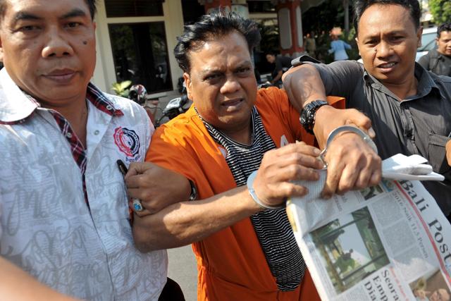 Indonesian plainclothes policemen escort Indian gangster Rajendra Nikalje (C), widely known as Chhota Rajan, as they walk at Denpasar police office. (REUTERS) Indonesian plainclothes policemen escort Indian gangster Rajendra Nikalje (C), widely known as Chhota Rajan, as they walk at Denpasar police office. (REUTERS)