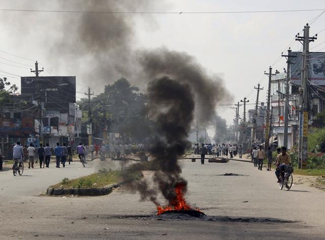 Smoke from tires bellows set on fire by the ethnic Madhesis at Birgunj. (AP) Smoke from tires bellows set on fire by the ethnic Madhesis at Birgunj. (AP)