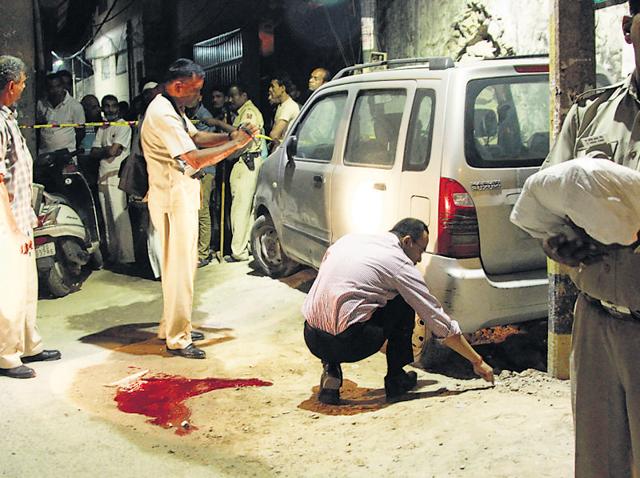 Police at the spot where a suspected gangster was shot dead, near Saket Select City Mall, on Sunday. (Waseem Gashroo/HT Photo) Police at the spot where a suspected gangster was shot dead, near Saket Select City Mall, on Sunday. (Waseem Gashroo/HT Photo)