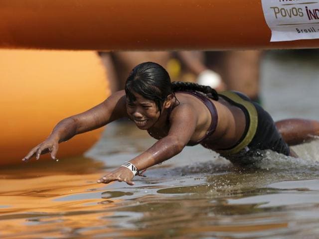 An indigenous woman from Gaviao tribe jumps into the water on her way to winning a swimming competition during the first World Games for Indigenous Peoples in Palmas, Brazil. (REUTERS) An indigenous woman from Gaviao tribe jumps into the water on her way to winning a swimming competition during the first World Games for Indigenous Peoples in Palmas, Brazil. (REUTERS)