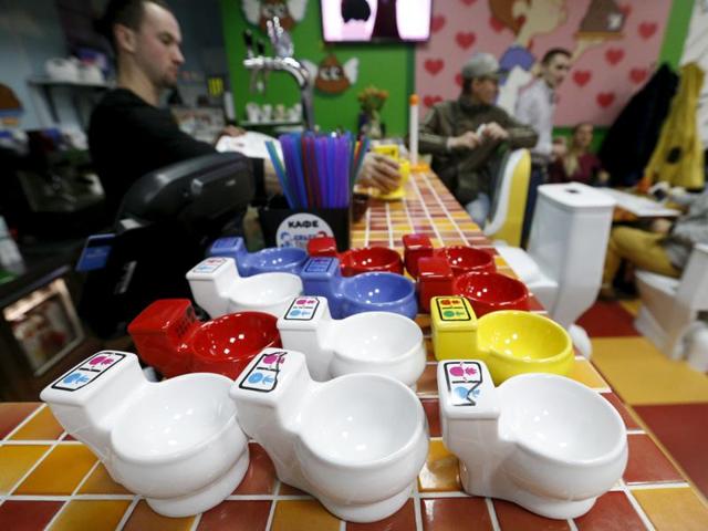 Cups designed like urinals are seen on a counter at Crazy Toilet Cafe in Moscow. (REUTERS)