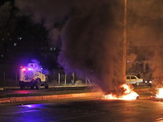 A police jeep patrols as garbage set on fire by supporters of the pro-Kurdish Peoples's Democratic Party (HDP) are seen during minor clashes with police in Diyarbakir. (AP)