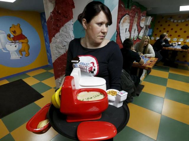 A waitress serves an order at Crazy Toilet Cafe on October 30. The restaurant admits it will probably mainly draw one-time novelty visitors rather than repeat clients. (REUTERS)