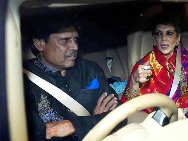 Former Cricketer Kapil Dev with his wife arrives to attend wedding reception of Harbhajan Singh and Geeta Basra in New Delhi on Sunday. (PTI)