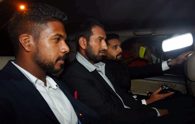 Cricketers Cheteshwar Arvind Pujara,Murli Vijay, Varun Raymond Aaron arrives to attend wedding reception of Harbhajan Singh and Geeta Basra in New Delhi on Sunday. (PTI)