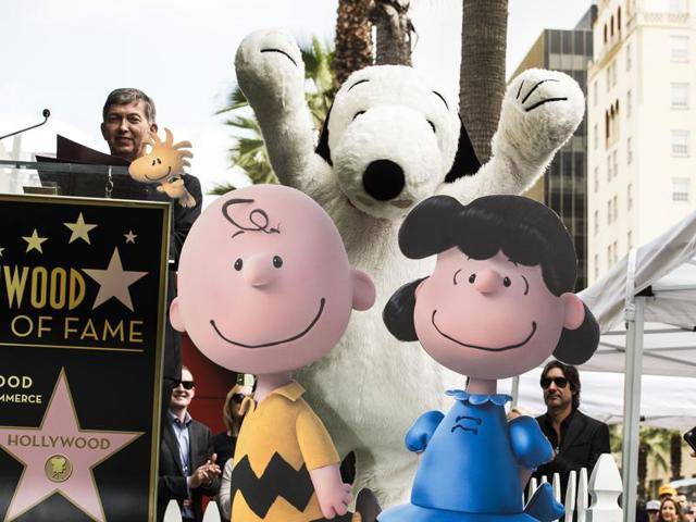 Snoopy celebrates at his star unveiling ceremony on the Hollywood Walk of Fame in Hollywood, California. At left is Hollywood Chamber of Commerce CEO and President Leron Gubler. Snoopy co-stars with Charlie Brown and Lucy in The Peanuts Movie. (AFP)