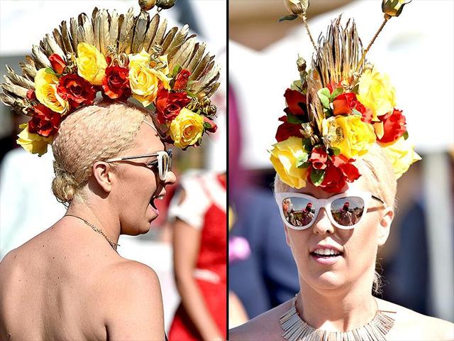 A racegoer groomed in mohawk headgear, poses for a photograph ahead of the annual Fashion on the Field competition at Flemington Racecourse on Melbourne Cup day in Melbourne. (Reuters)