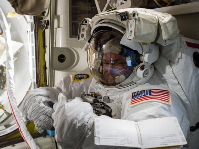 Expedition 45 Commander Scott Kelly tries on his spacesuit for a fit check inside the U. Quest airlock of the International Space Station. (Photo courtesy: nasa.gov)