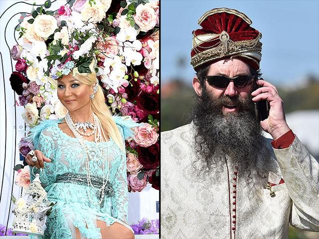 A racegoer sporting her blue laced dress and another suited in an Indian sherwani. (AP/AFP)