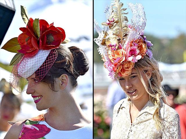 Racegoers looks great in floral headgear. (AFP)