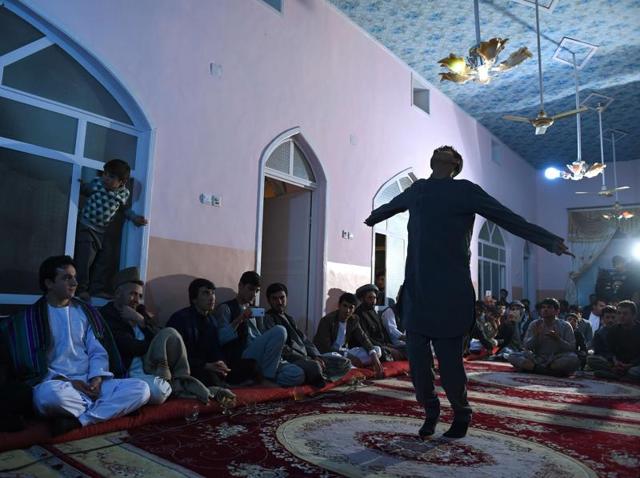 In this photo, an Afghan man dances during a wedding ceremony inside a house at Khoja Paytakht in Maimana, the capital of the northern province of Faryab. Ankle bells chimed as male dancers shimmied beneath chandeliers in midnight wedding revelry that drew together an entire frontline Afghan village after its residents humiliatingly routed the Taliban. (AFP Photo) In this photo, an Afghan man dances during a wedding ceremony inside a house at Khoja Paytakht in Maimana, the capital of the northern province of Faryab. Ankle bells chimed as male dancers shimmied beneath chandeliers in midnight wedding revelry that drew together an entire frontline Afghan village after its residents humiliatingly routed the Taliban. (AFP Photo)