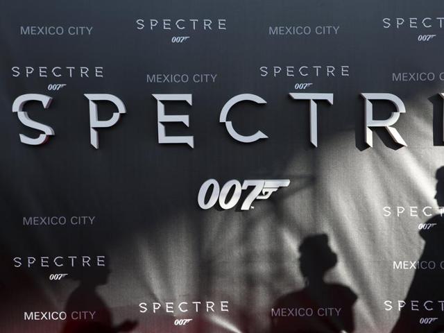 Dancers cast their shadows on a banner promoting the new James Bond 007 film Spectre during a red carpet at the Mexican premiere in Mexico City. (REUTERS)