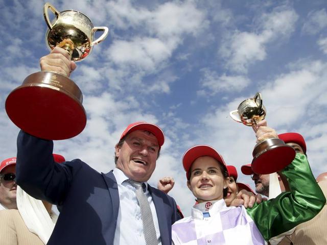 Trainer Darren Weir (L) and jockey Michelle Payne celebrate with their cups after emerging victorious with their horse -- Prince of Penzance -- in race 7 the Melbourne Cup during the Melbourne Cup race day at Flemington Racecourse in Melbourne, Victoria. Michelle Payne became the first female jockey to win the A$6.2 million (£2.9 million) Melbourne Cup on Tuesday as she rode rank outsider Prince of Penzance to victory in Australia's richest and most prestigious race. (Reuters Photo)