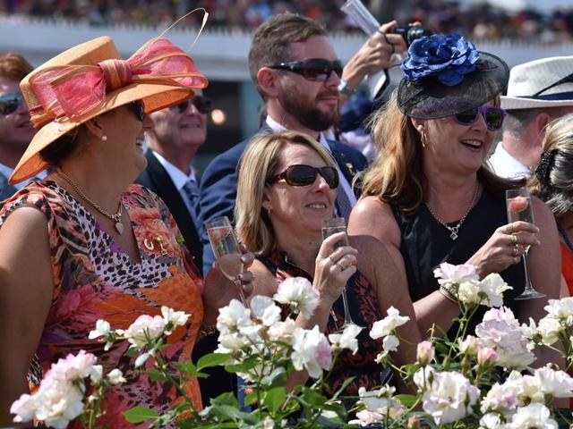 Racegoers watch horses enter the track at Flemington Racecourse. (AFP)