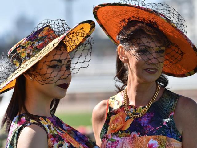 Racegoers prepare for the annual Fashion on the Field competition at Flemington Racecourse . (AFP)