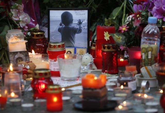 A portrait of 10 month Darina Gromova, a victim of a plane crash, is surrounded by flowers and candles at an entrance of Pulkovo airport outside St Petersburg, Russia. (AP Photo)