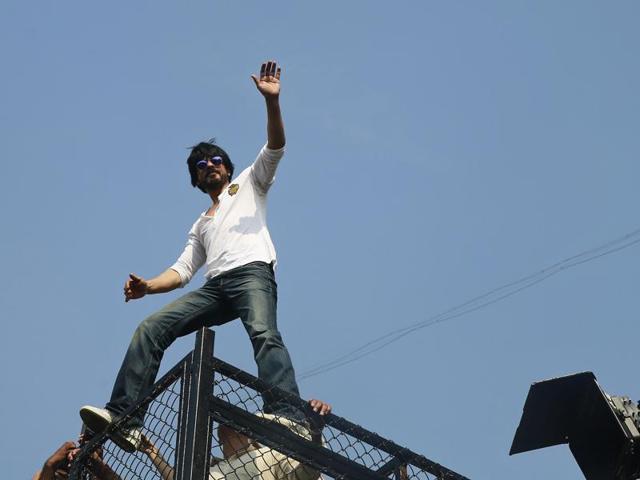 Shah Rukh Khan waves to his fans who have gathered outside his home on his birthday in Mumbai, Monday. (AP) Shah Rukh Khan waves to his fans who have gathered outside his home on his birthday in Mumbai, Monday. (AP)