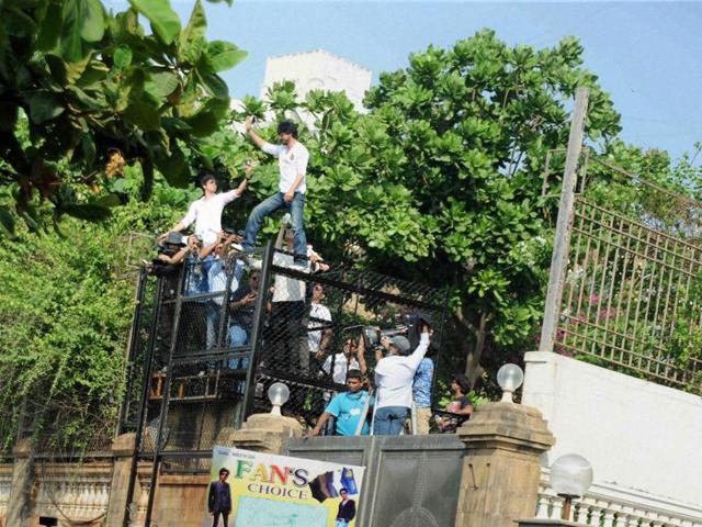 Shah Rukh Khan waves to fans and well-wishers gathered outside his residence to greet him on his 50th Birthday in Mumbai on Monday. (PTI) Shah Rukh Khan waves to fans and well-wishers gathered outside his residence to greet him on his 50th Birthday in Mumbai on Monday. (PTI)