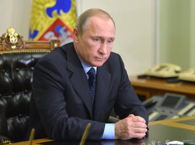 Russian President Vladimir Putin listens during a meeting with transport minister Maxim Sokolov, who had arrived from Egypt, at the Novo-Ogaryov residence outside Moscow. (AP Photo)