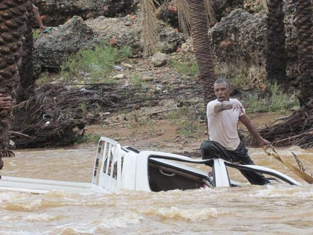 A man gestures as he tries to save a vehicle swept away by flood waters in Yemen's island of Socotra. A rare tropical cyclone packing hurricane-force winds killed three people and injured scores on the island. (Reuters Photo) A man gestures as he tries to save a vehicle swept away by flood waters in Yemen's island of Socotra. A rare tropical cyclone packing hurricane-force winds killed three people and injured scores on the island. (Reuters Photo)