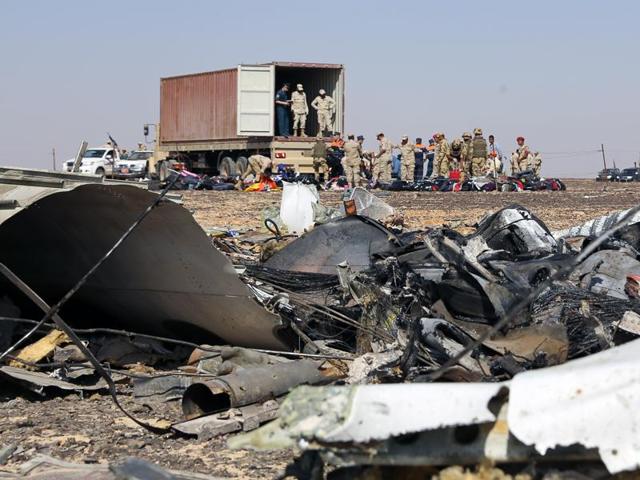 A handout picture taken on November 2, 2015 and released on November 3, 2015 by Russia's Emergency Ministry shows Russian emergency services personnel and Egyptian servicemen working at the crash site of a A321 Russian airliner in Wadi al-Zolomat, a mountainous area of Egypt's Sinai Peninsula.(AFP)