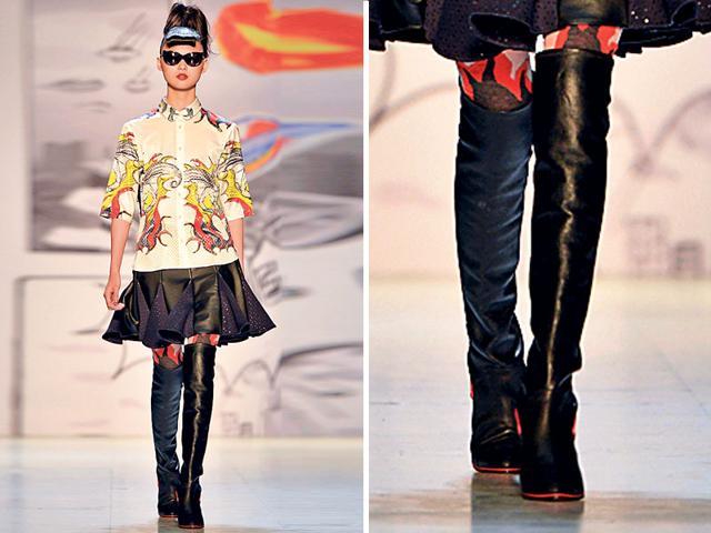 Pleated skater skirt with daring black boots. (AFP)