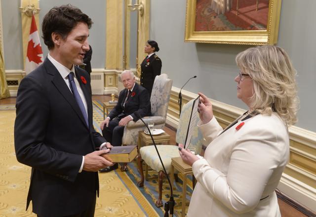 Justin Trudeau takes the oath of office as he is sworn in as Canadian Prime Minister. (AFP) Justin Trudeau takes the oath of office as he is sworn in as Canadian Prime Minister. (AFP)